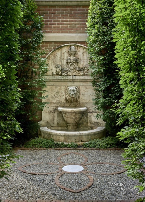 Antique Stone Wall Fountains, 
Old Water Fountains for Sale
An antique stone wall fountain nestled in a lush garden antique weathered surface 
Ancient Surfaces